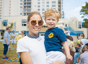 Photo of a woman holding a child. Link to Life Stage Gift Planner Under Age 45 Situations.