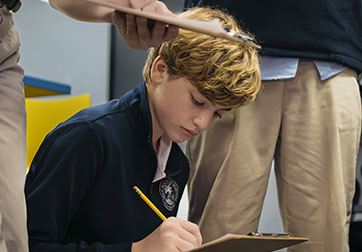 Photo of a student taking notes. Links to Gifts of Cash, Checks, and Credit Cards page.