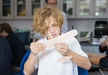 Photo of a student working on a project. Links to Gifts by Will page.