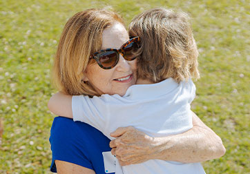 Photo of a woman holding a child. Links to Gifts from Retirement Plans page .